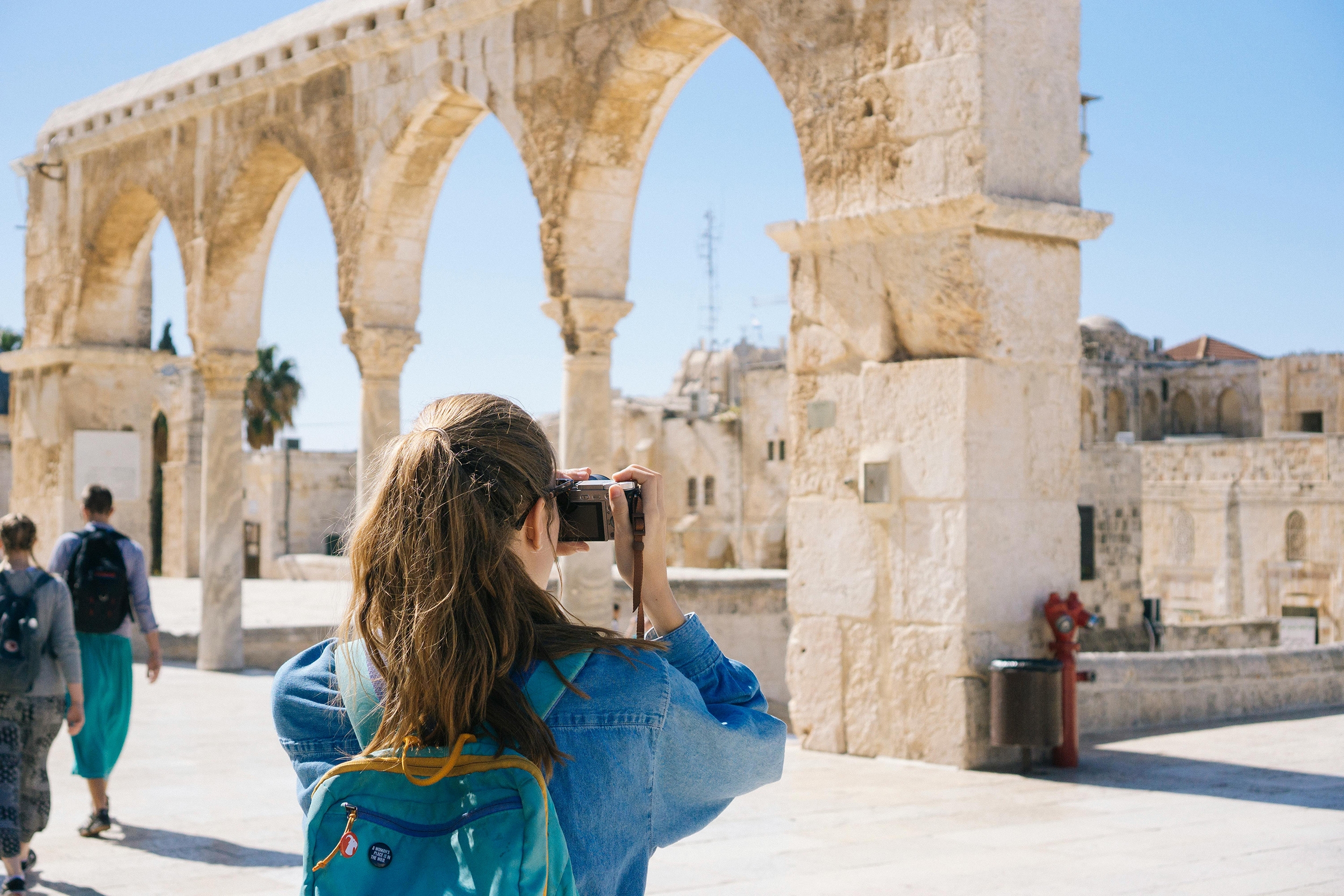 tourist taking a photo of ancient ruins