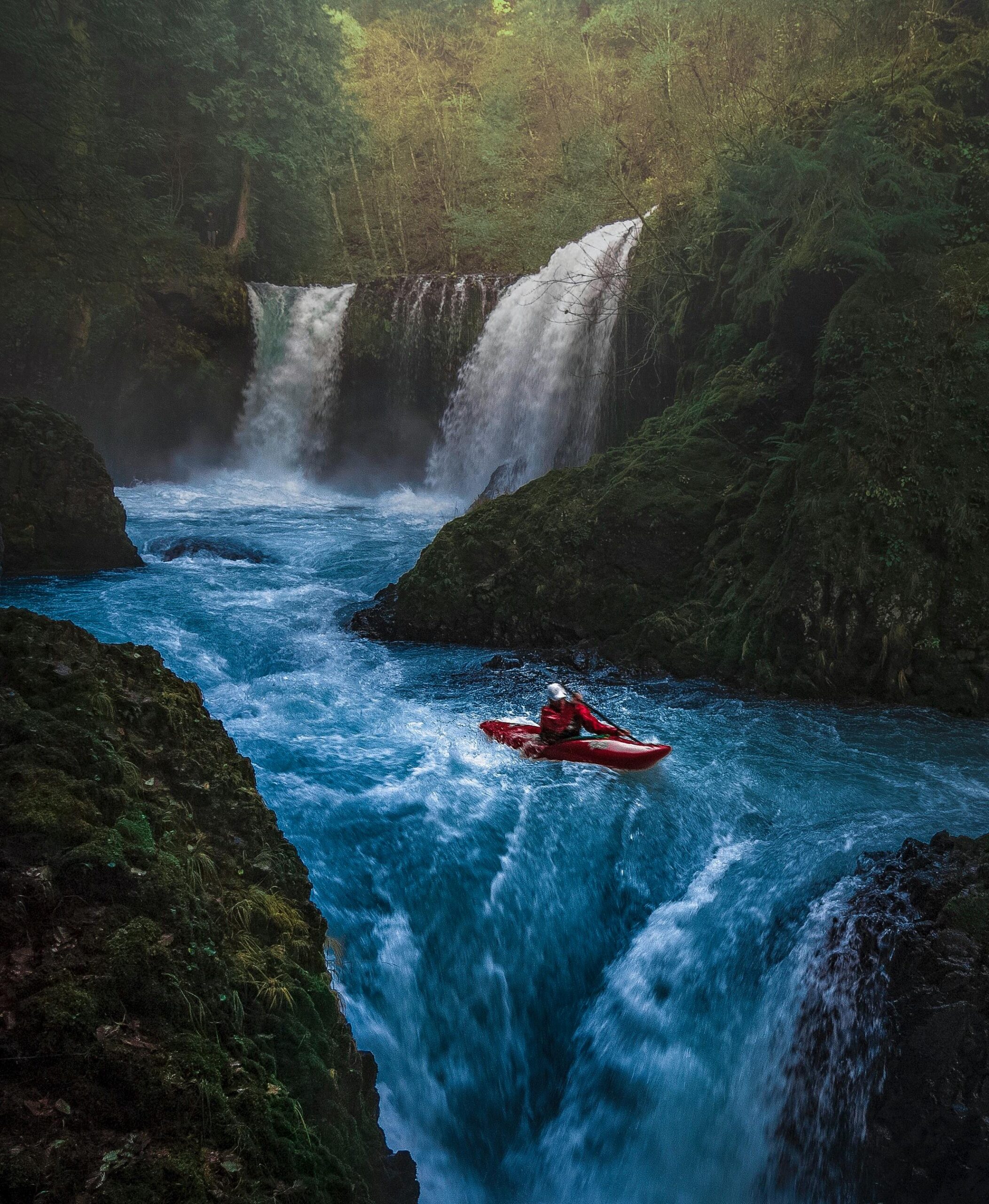 a one man canoe about to drop in to a chute